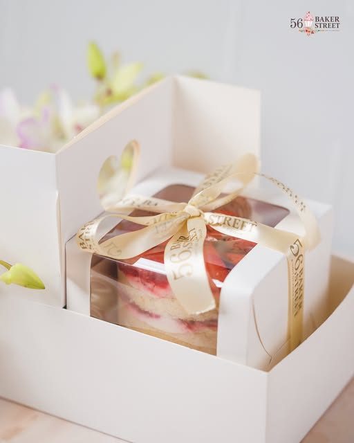 White gift box tied with gold ribbon