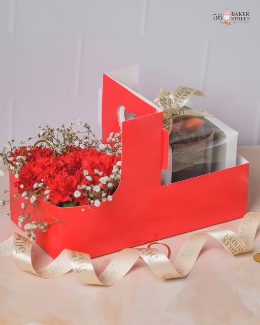 Red gift caddy with carnations and a mini cake