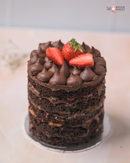 Chocolate naked cake with chocolate kisses and fresh strawberries by 56 Baker Street